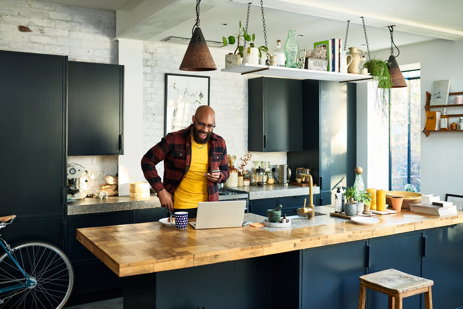 A man using a laptop in a kitchen