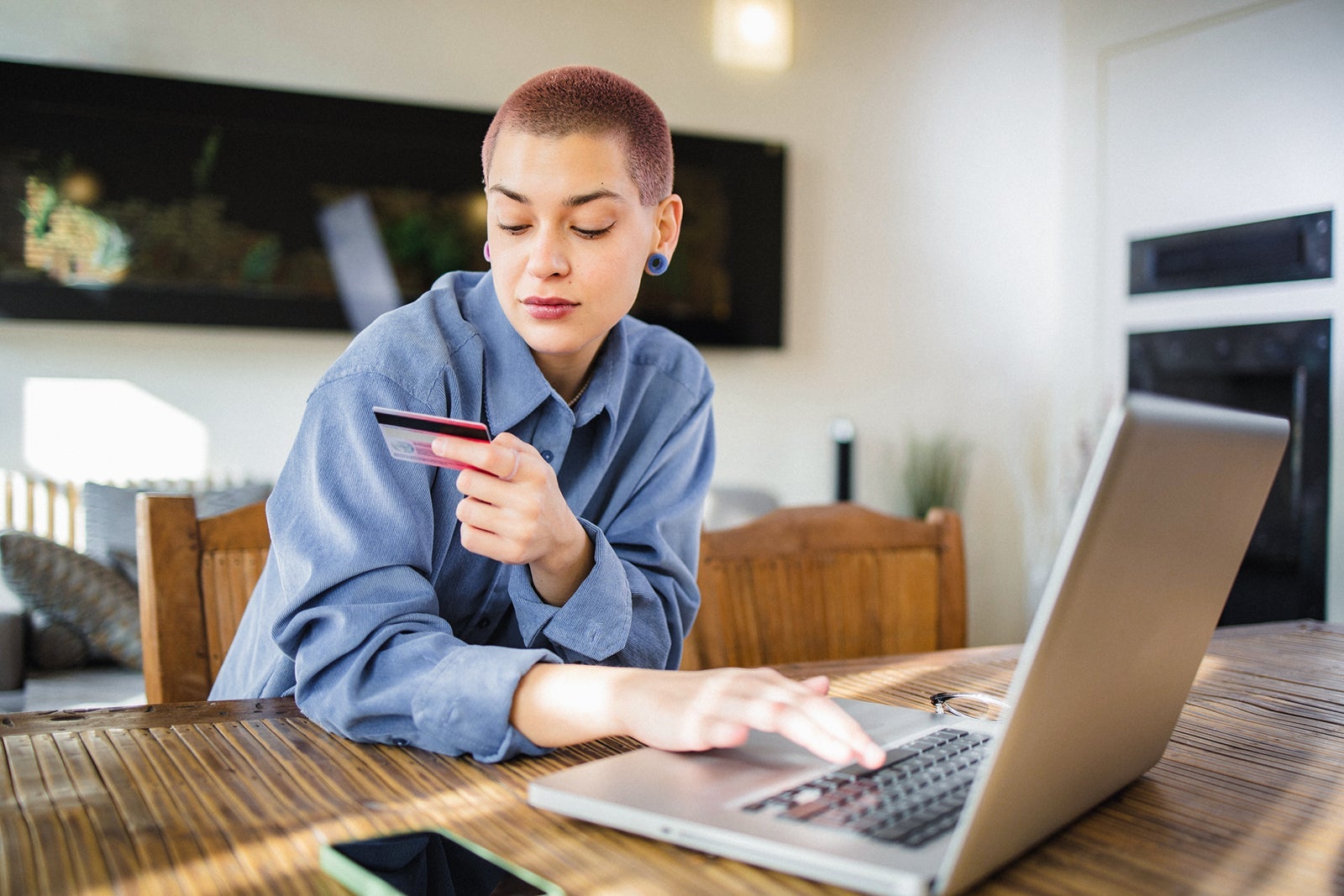 Person holding credit card while online shopping