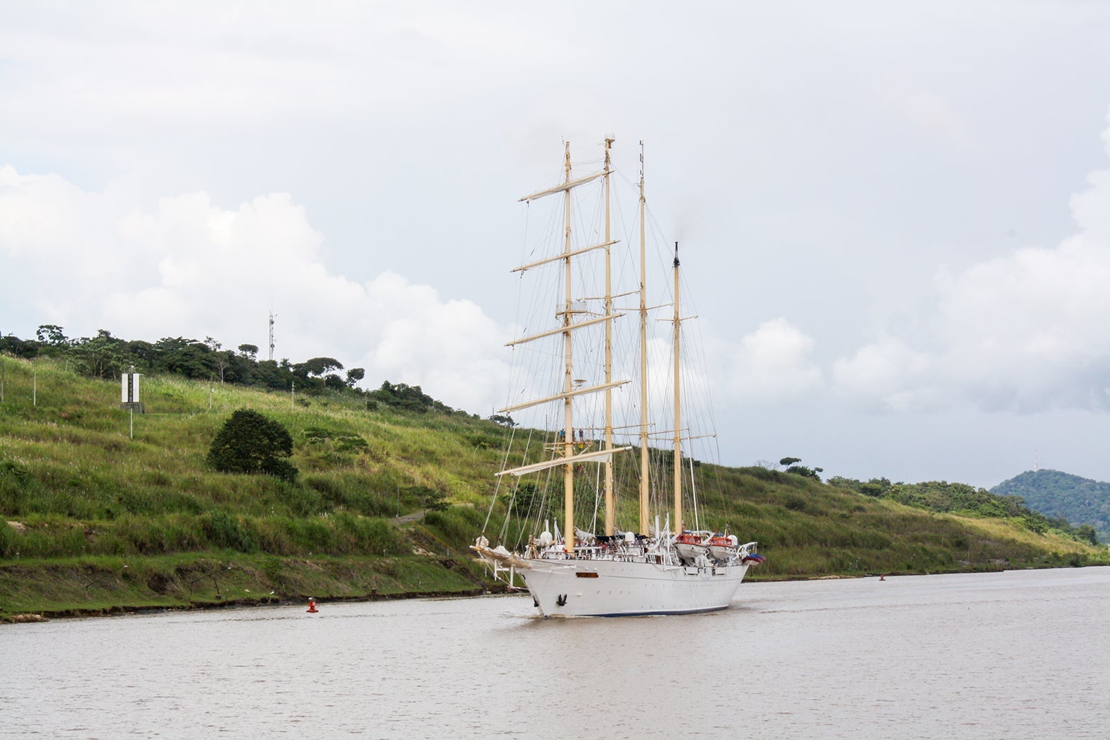 A small, white, masted sailing ship