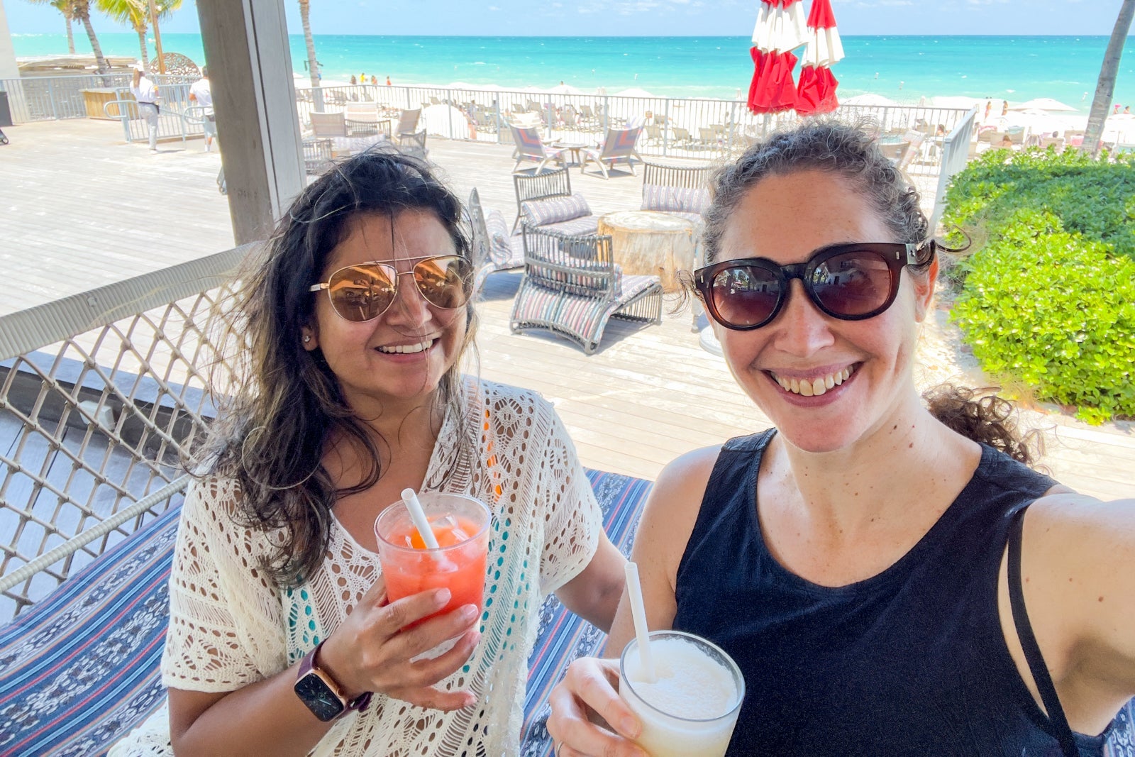 Two ladies on beach with drinks