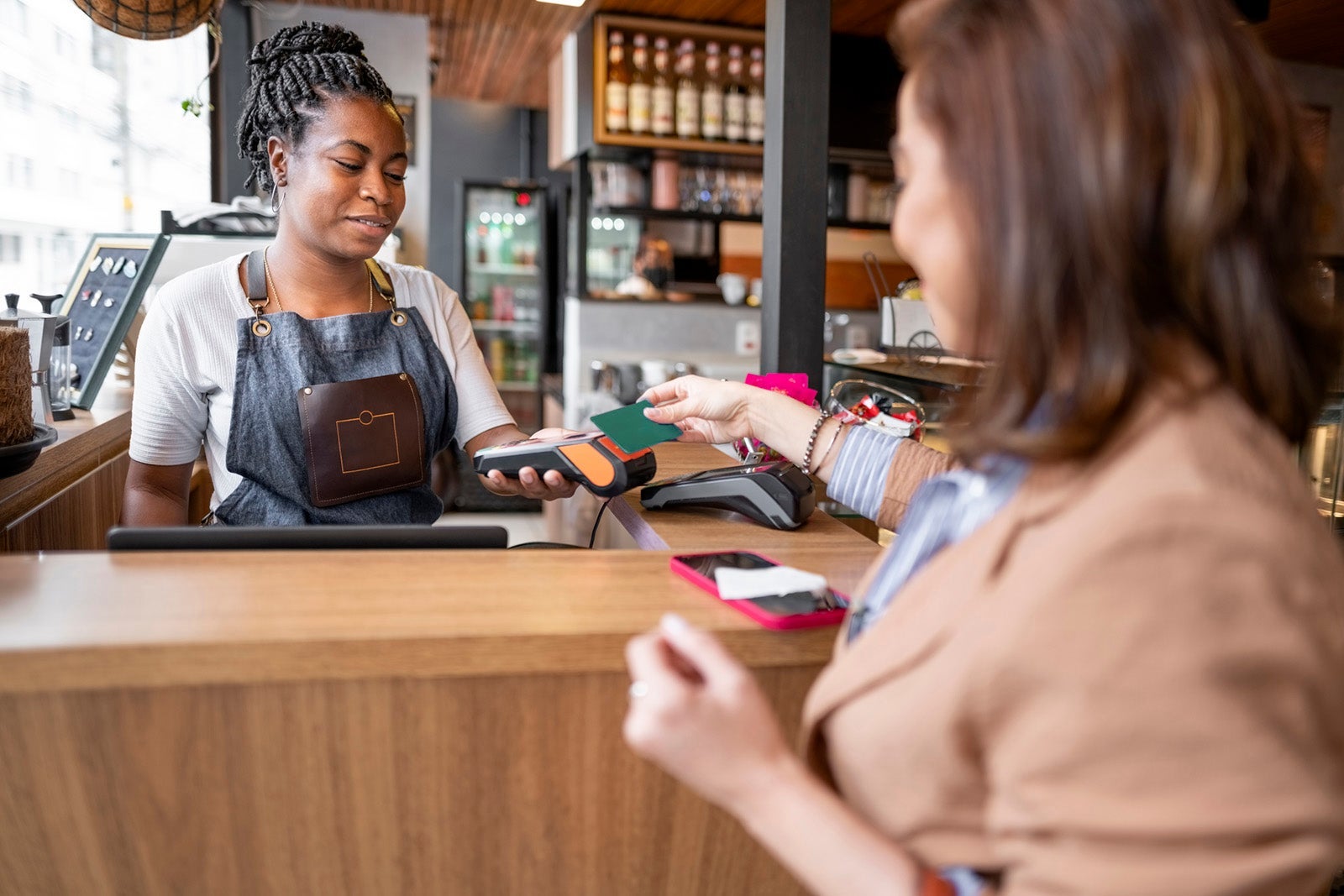 Customer paying cafe bill with contactless credit card