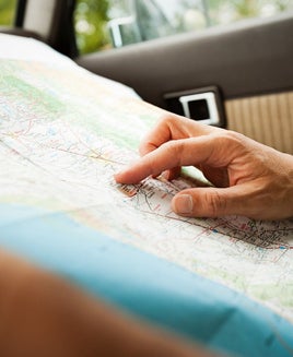 Person looking at a map in a car