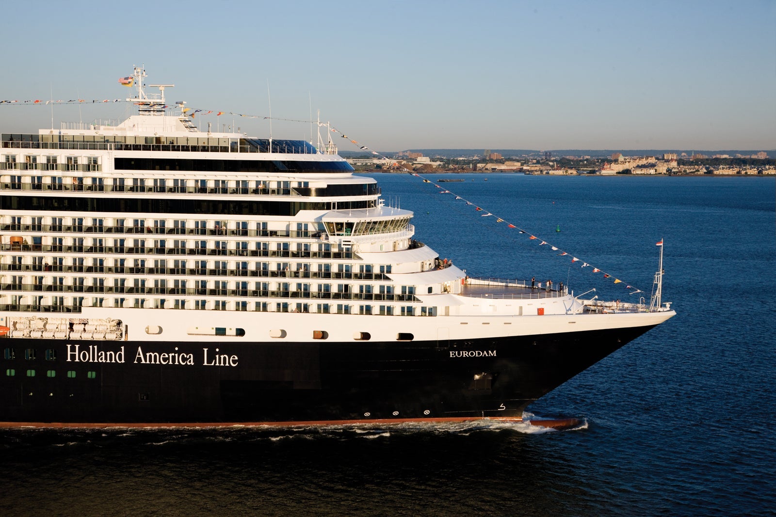 Side view of the front of a Holland America ship on blue water