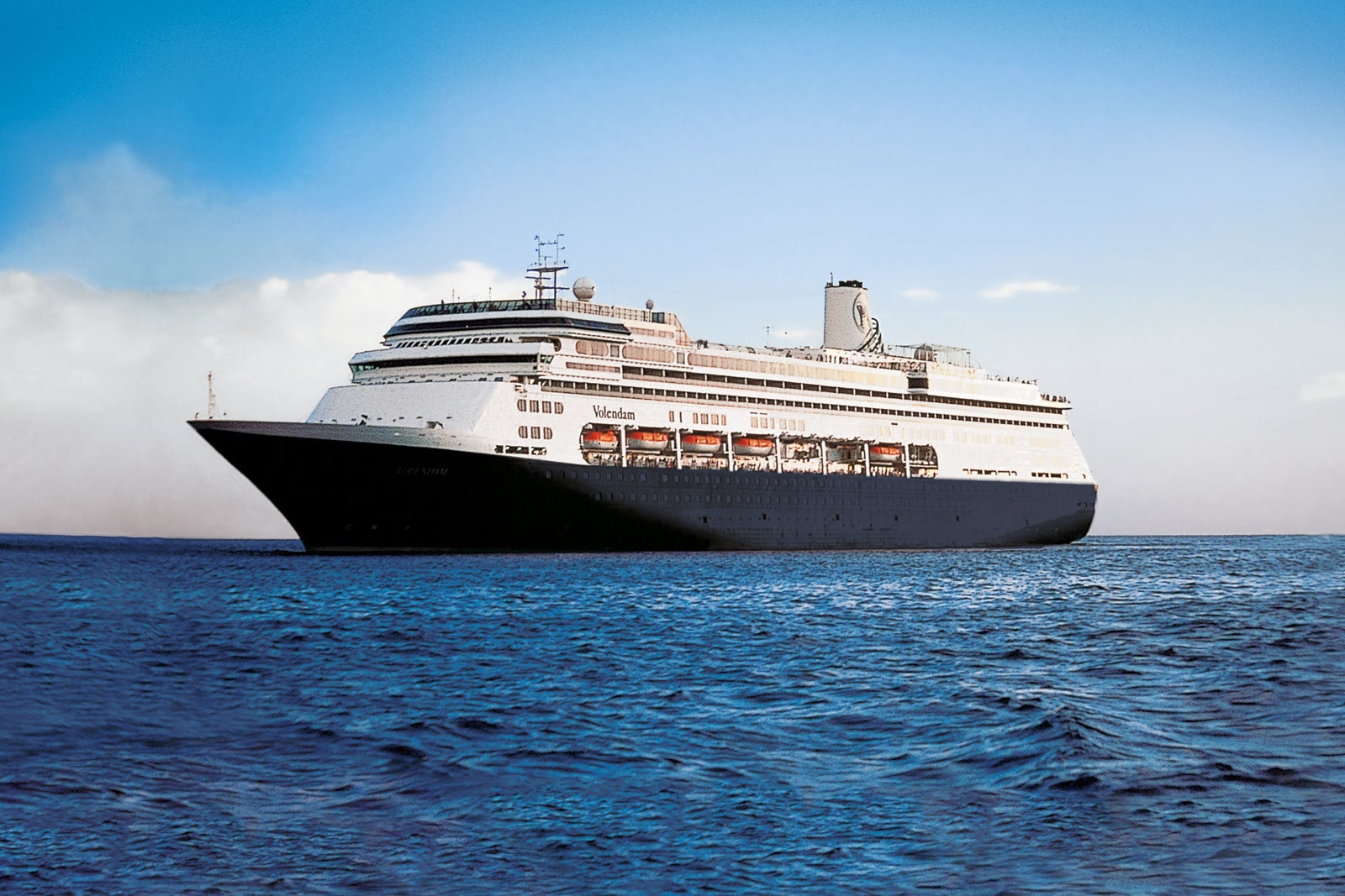 A Holland America ship floats on blue water