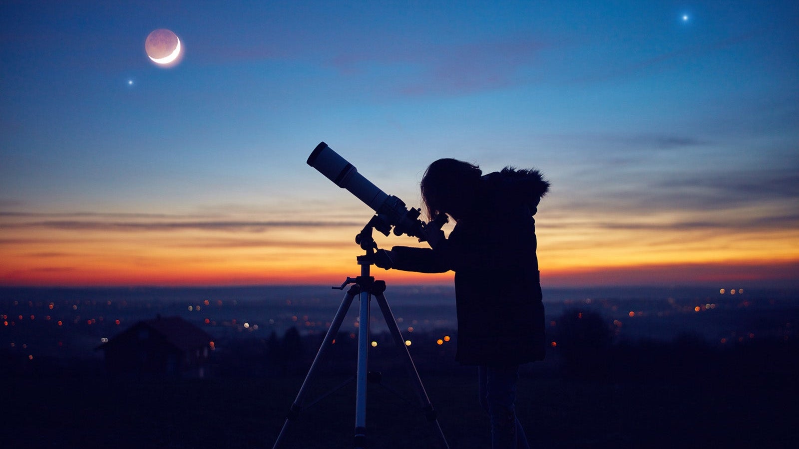 Child girl observing stars, planets, Moon and night sky with astronomical telescope.