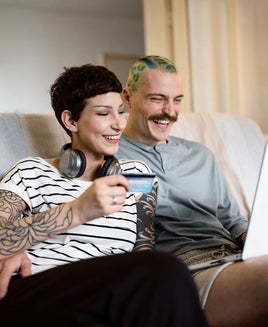 Urban young couple online shopping even during economic inflation