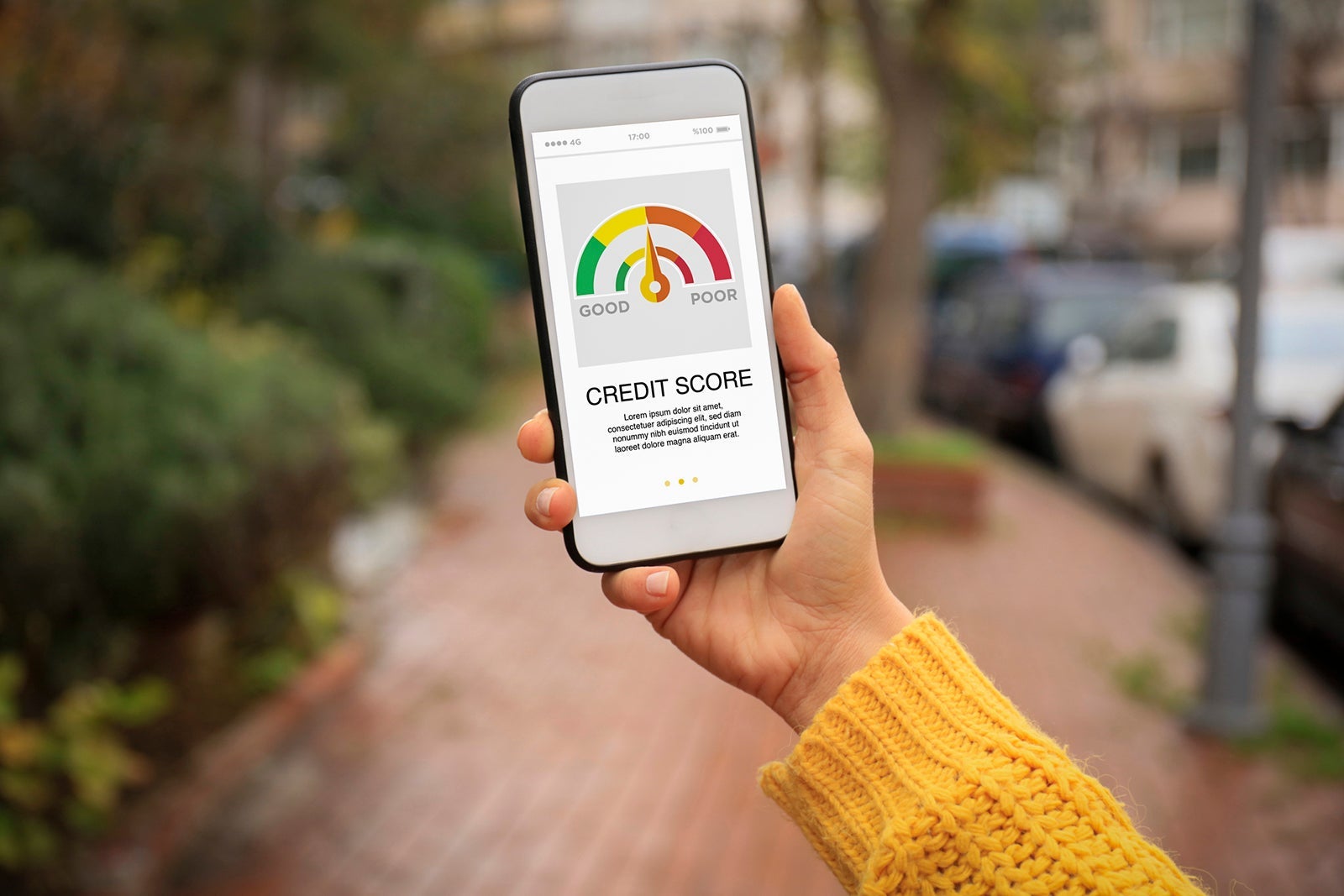 A person holding up a phone with credit score displayed