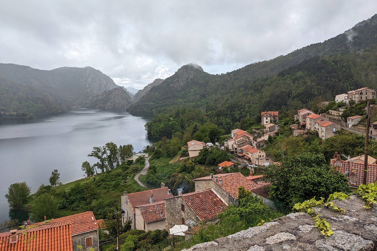 Mountain village about lake in Corsica