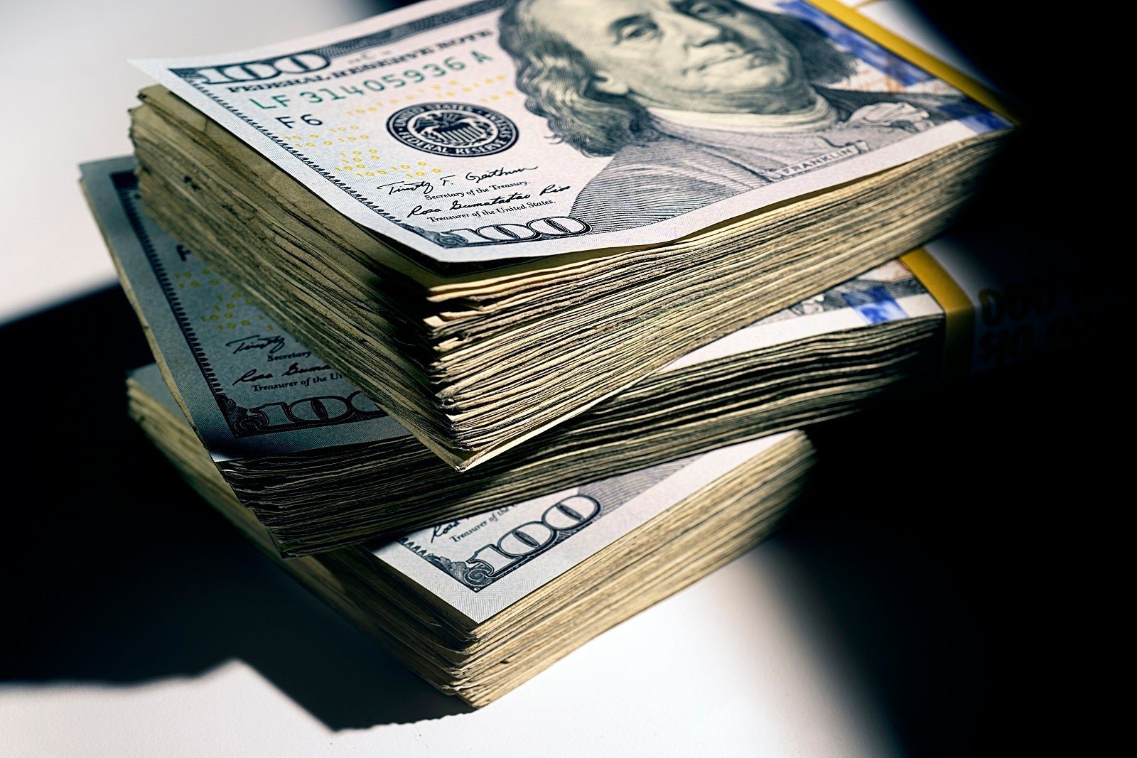 A picture of a stack of hundred dollar bills