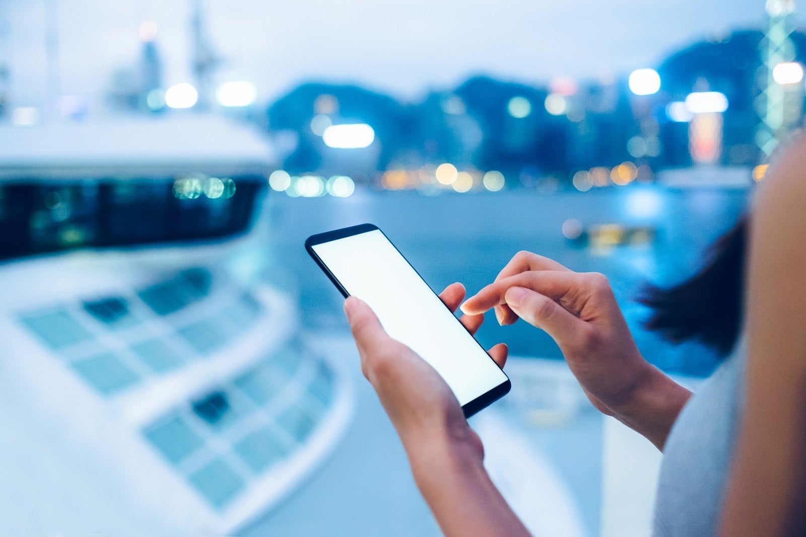 A cruise passenger's hands holding a mobile phone