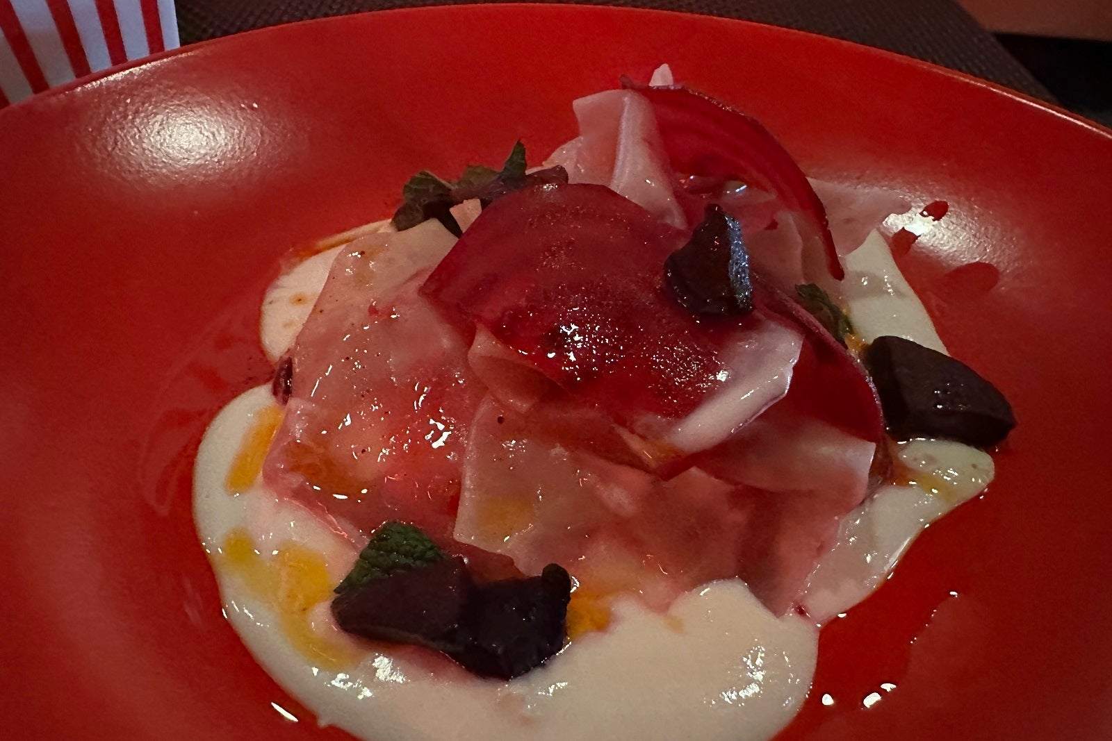 Beet-filled pierogi on a red plate