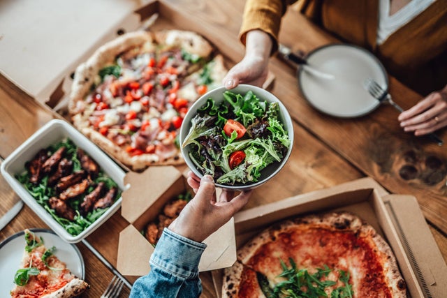 Couple sharing takeaway meal at home
