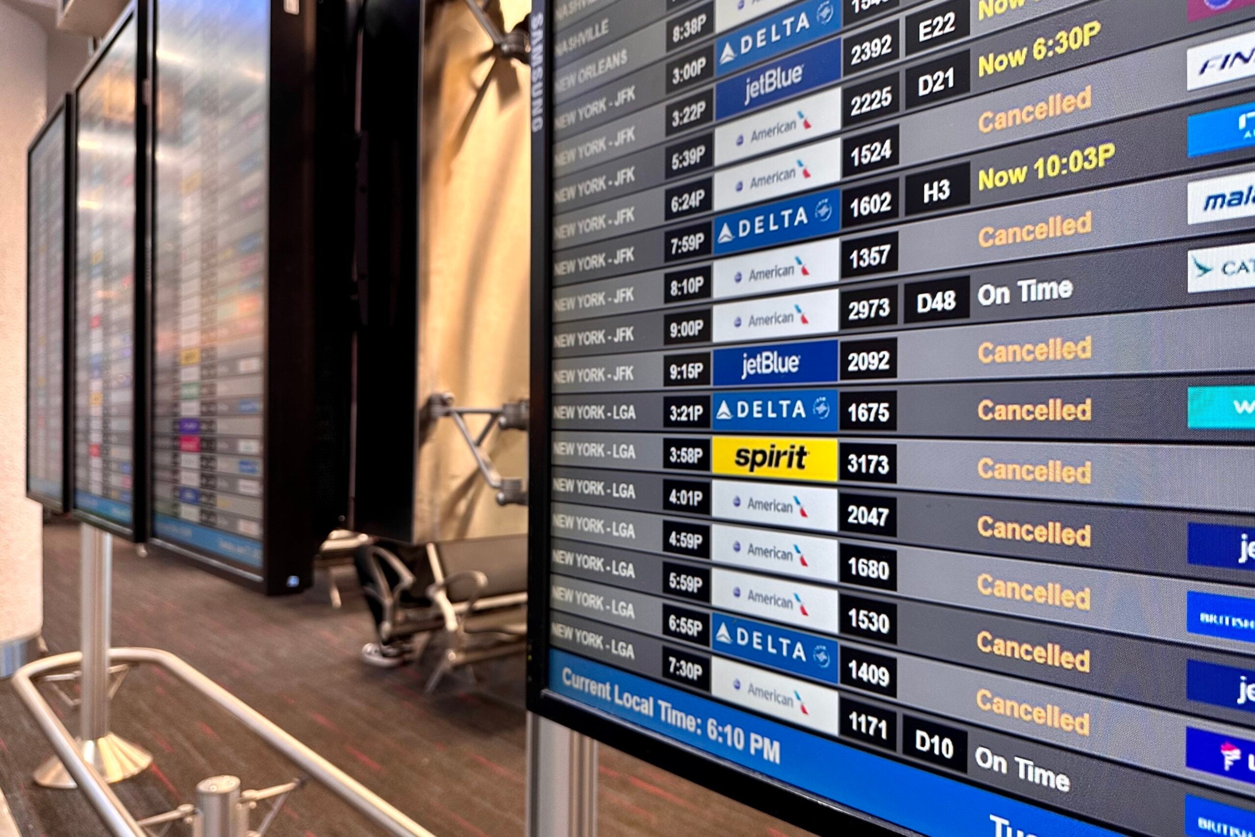 A screen shows the delayed and canceled flights at LaGuardia Airport (LGA). ZACH GRIFF/THE POINTS GUY