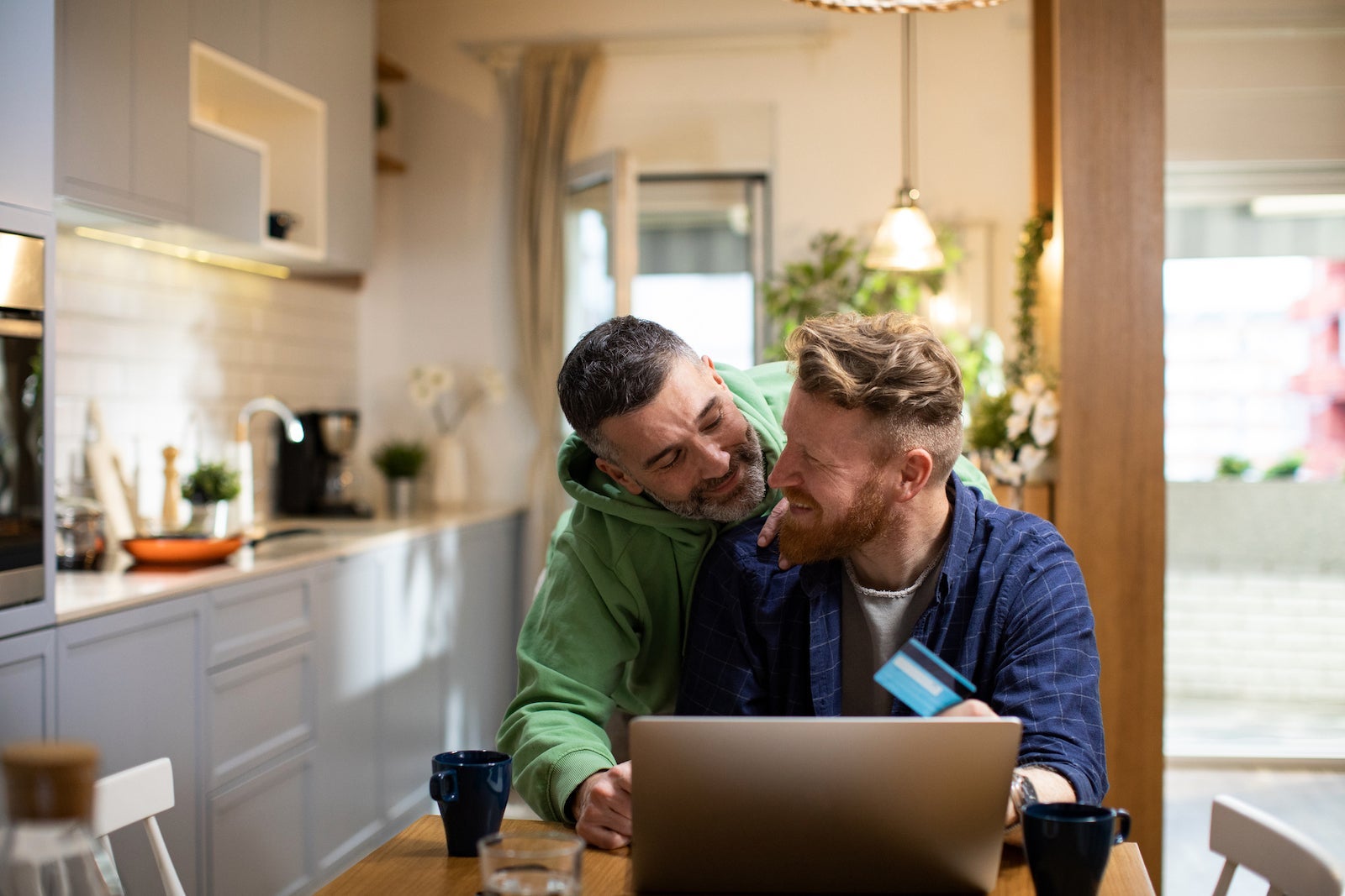 Young male couple online shopping from home