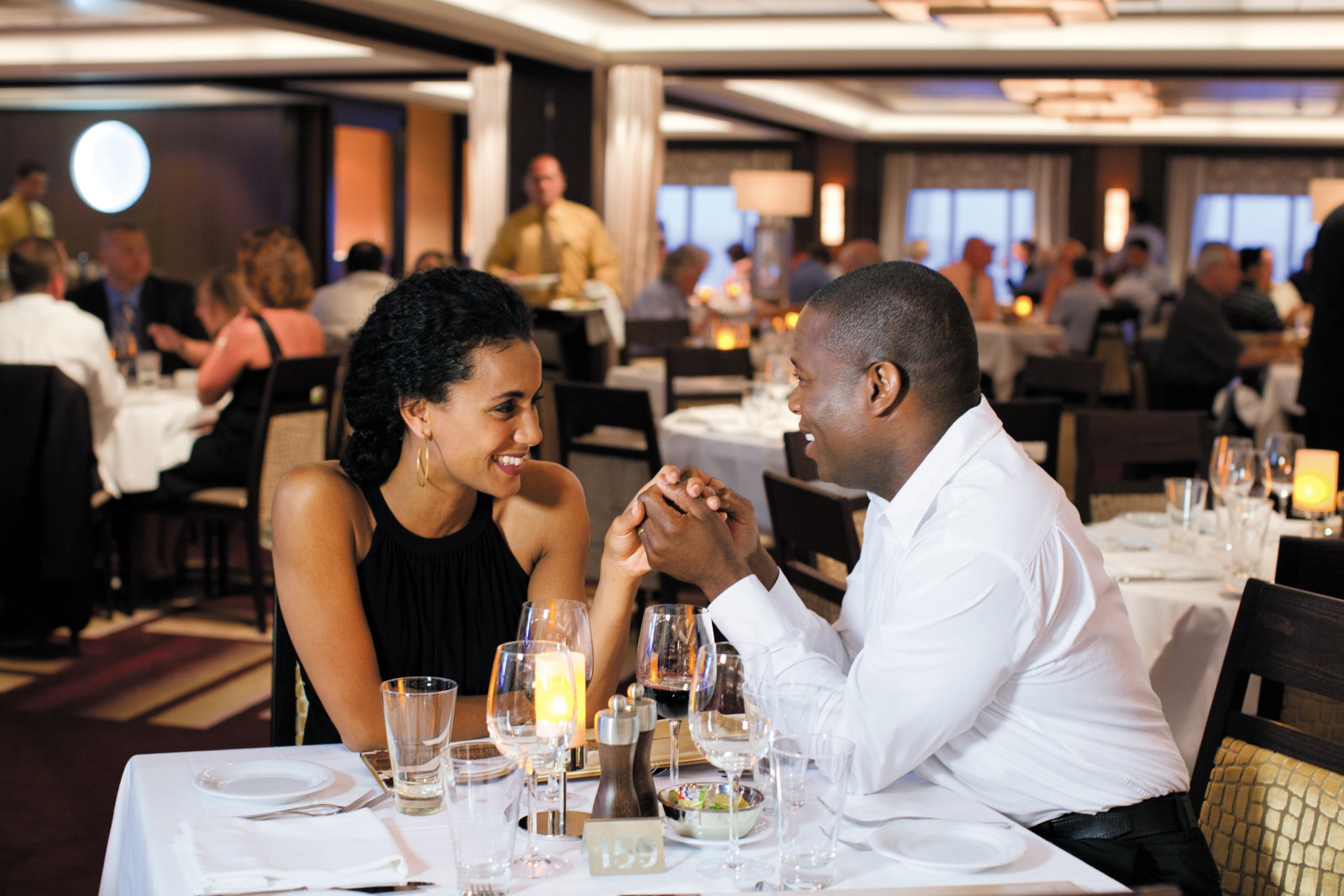 Couple holding hands in cruise ship dining room