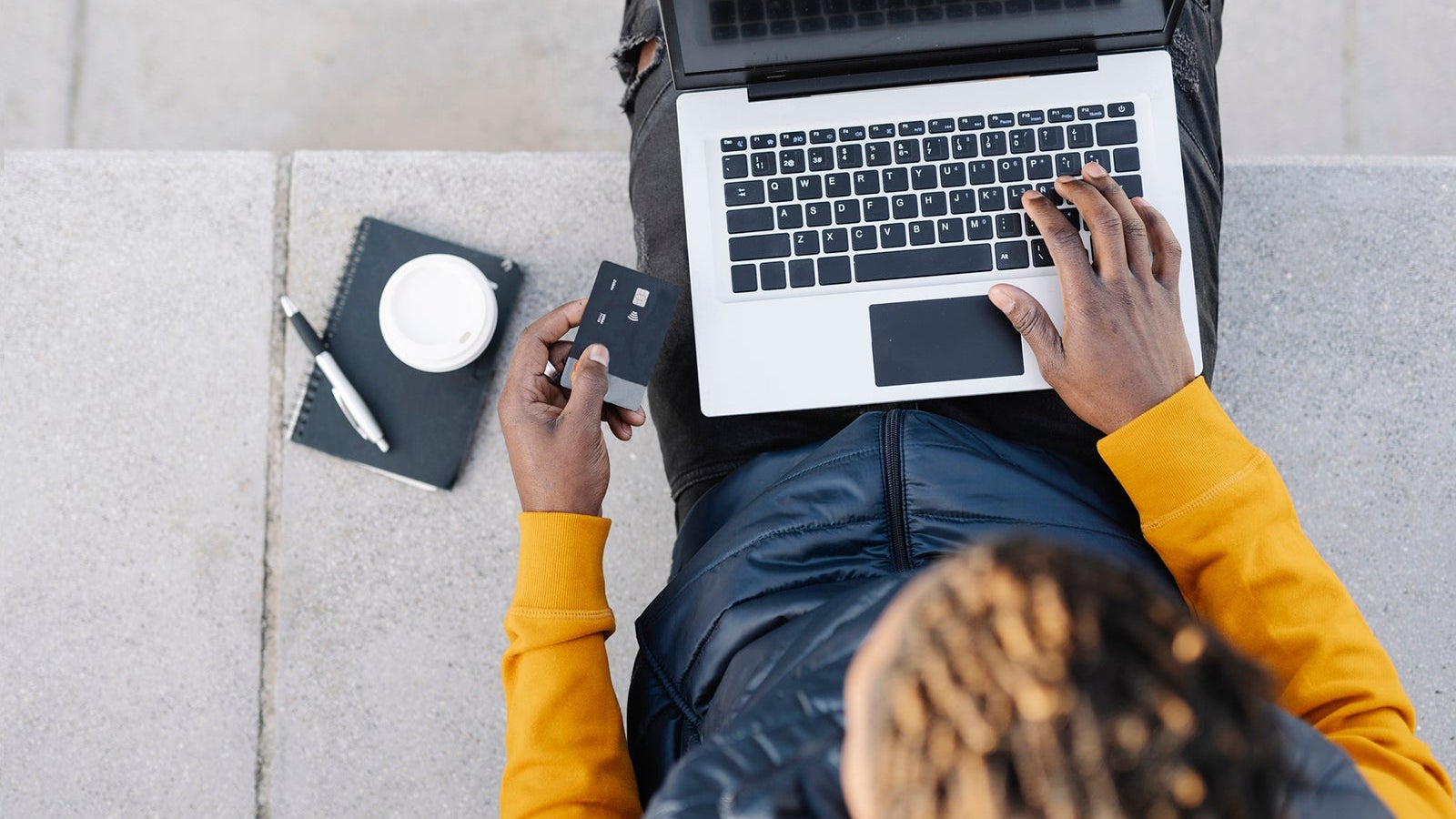 Top view of man using laptop and credit card for online shopping