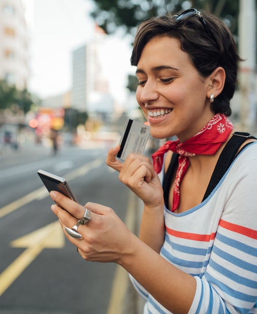 Woman using her card and phone