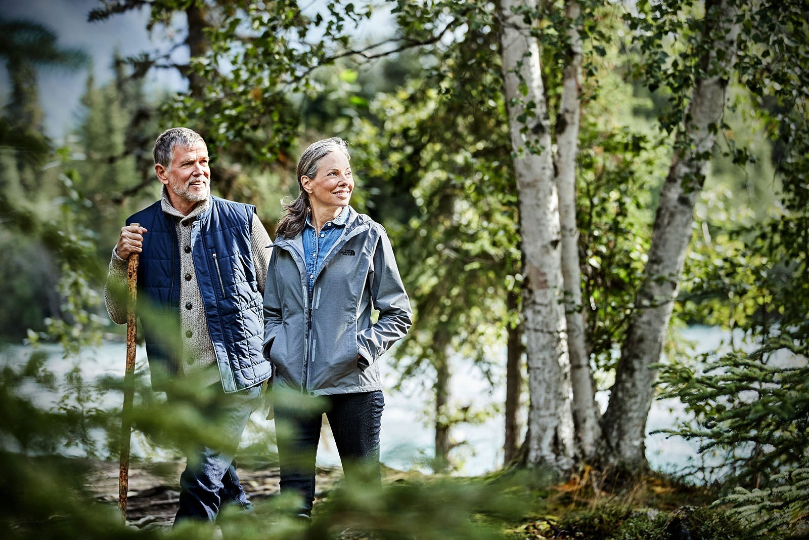 Older couple hiking in the forest in Alaska