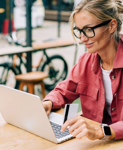 Young attractive caucasian business woman sitting in a cafe working on a laptop.