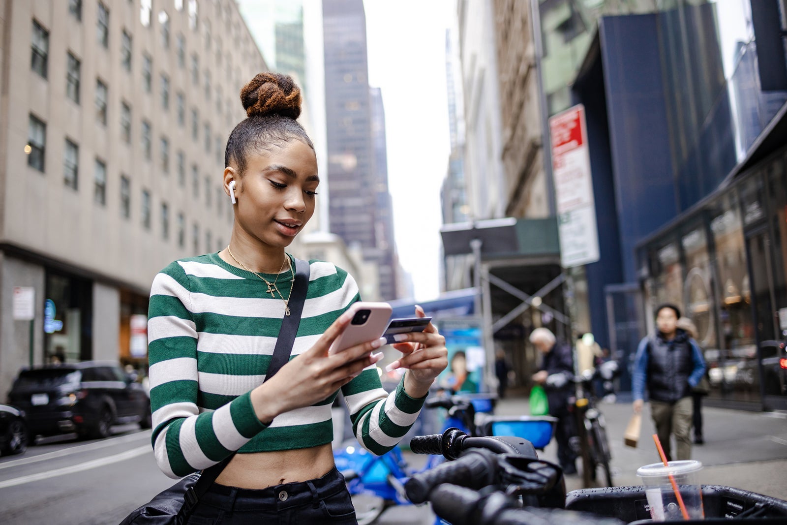 person using credit card on city street