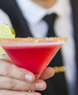 Waiter holds a martini