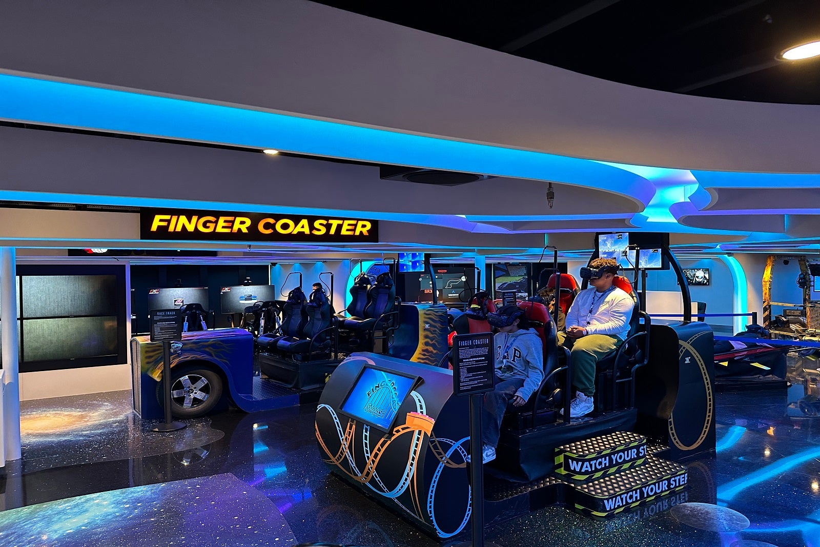 Cruise passengers on a virtual reality ride in the ship's arcade