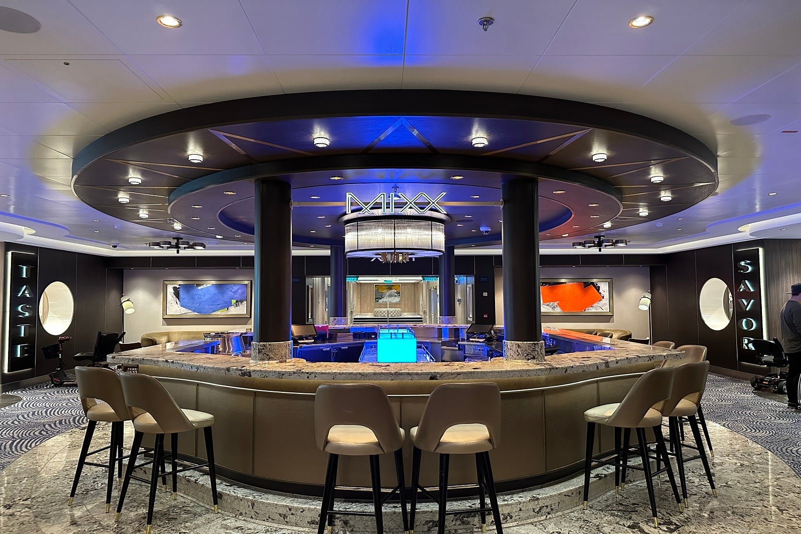 A circular bar with seating and a sign that says "Mixx"