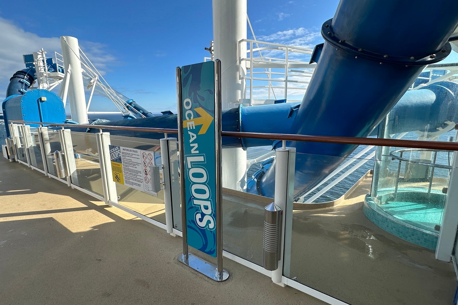 A sign for the Ocean Loops watersilde on a cruise ship