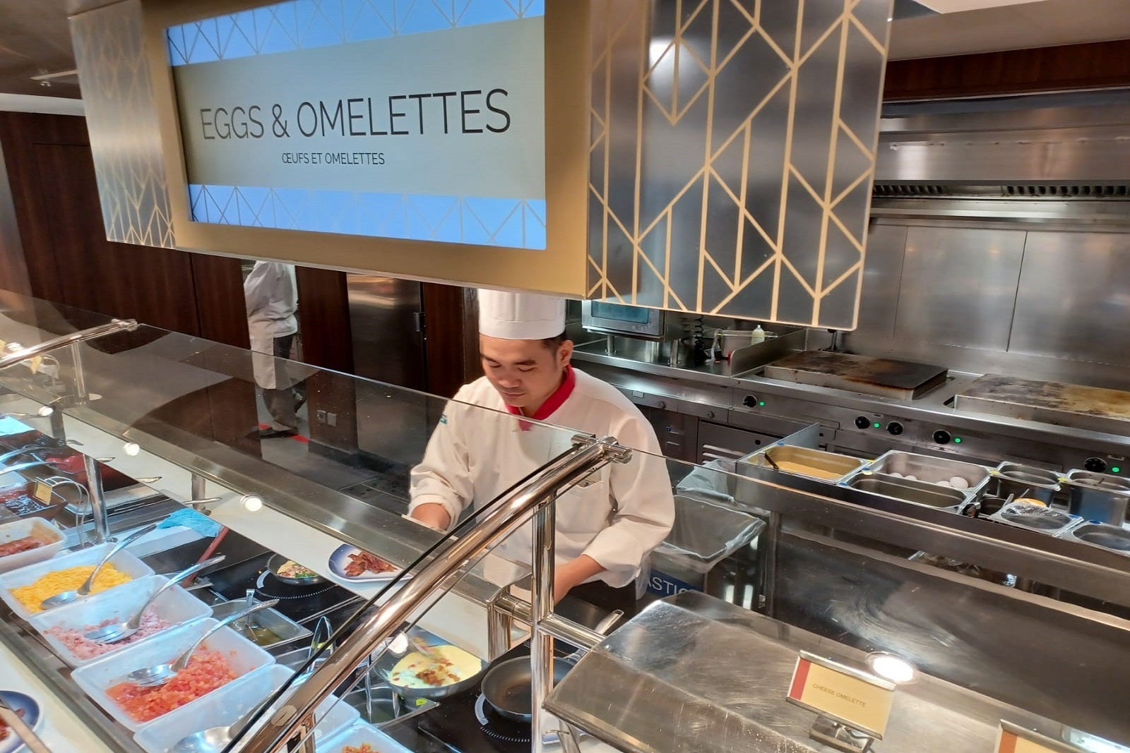 A chef preparing food at a cruise ship buffet