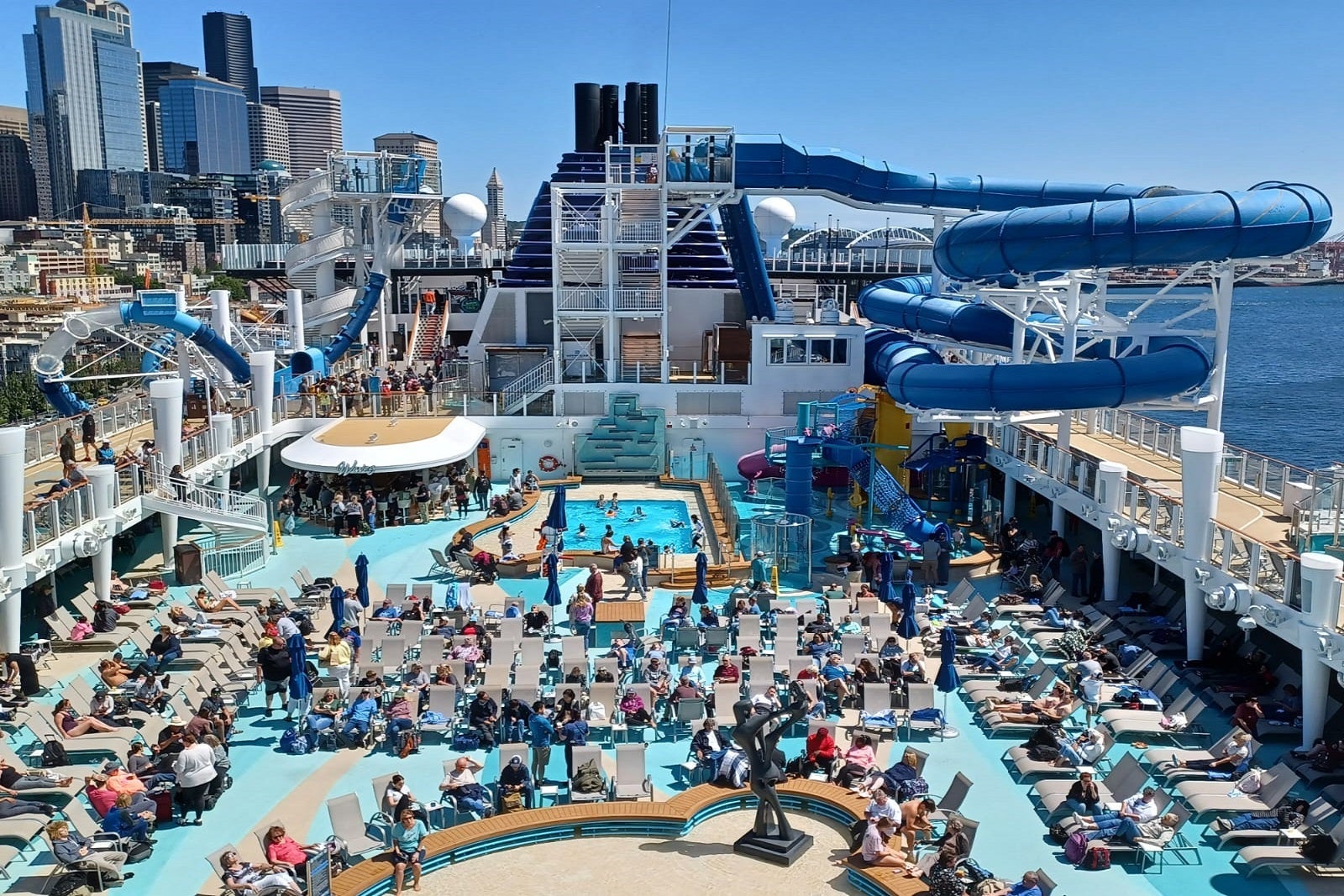 A view of a crowded cruise ship pool deck from above