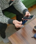 Someone holding a credit card and cellphone