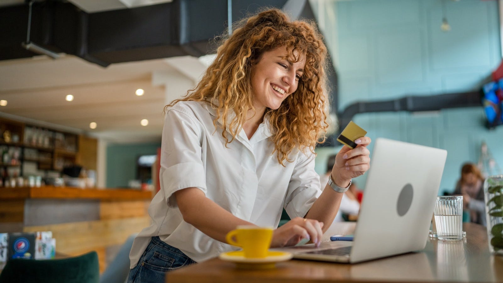 Woman happy caucasian female shopping online use credit card at cafe