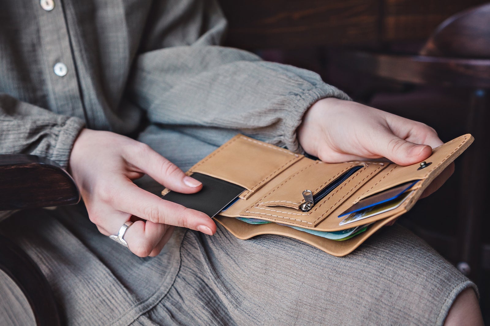 The woman takes out a credit card from wallet