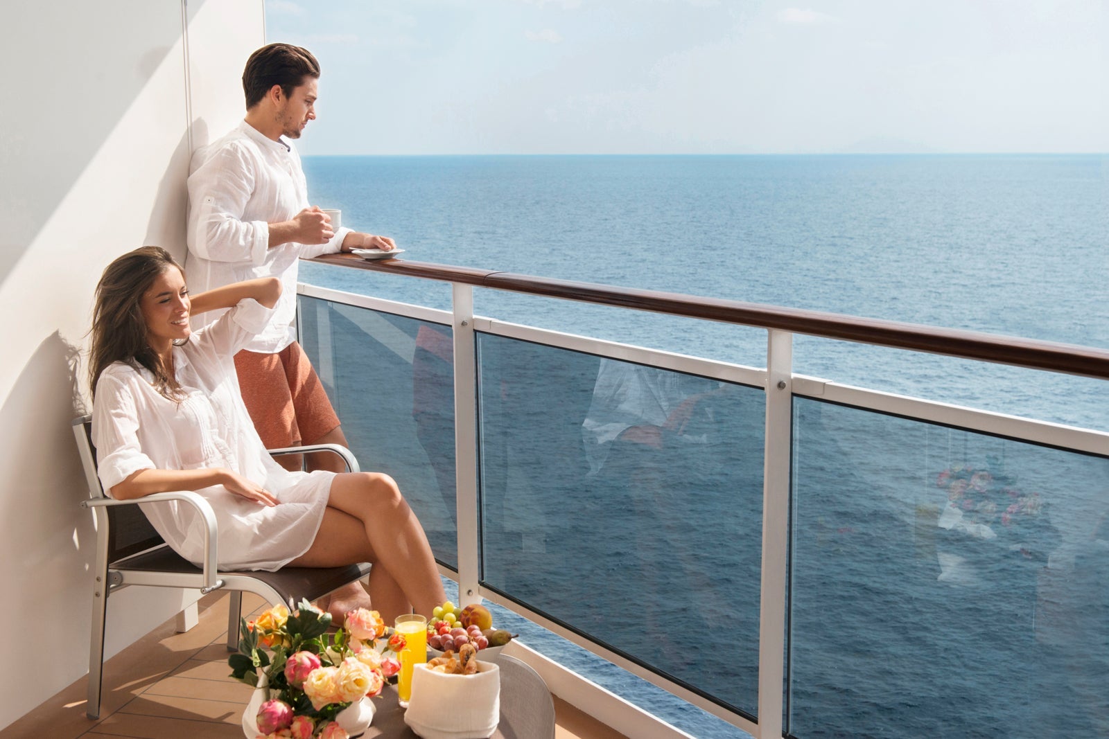 A couple relaxing on a cruise ship balcony