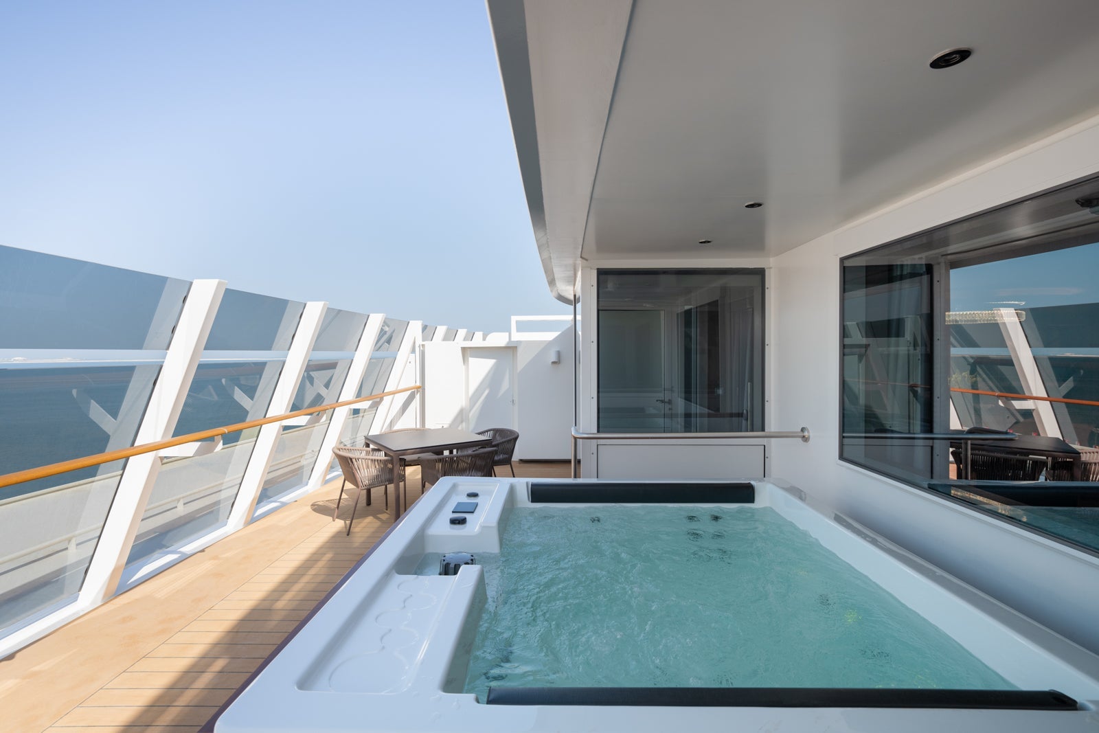 A cruise ship suite balcony with a hot tub