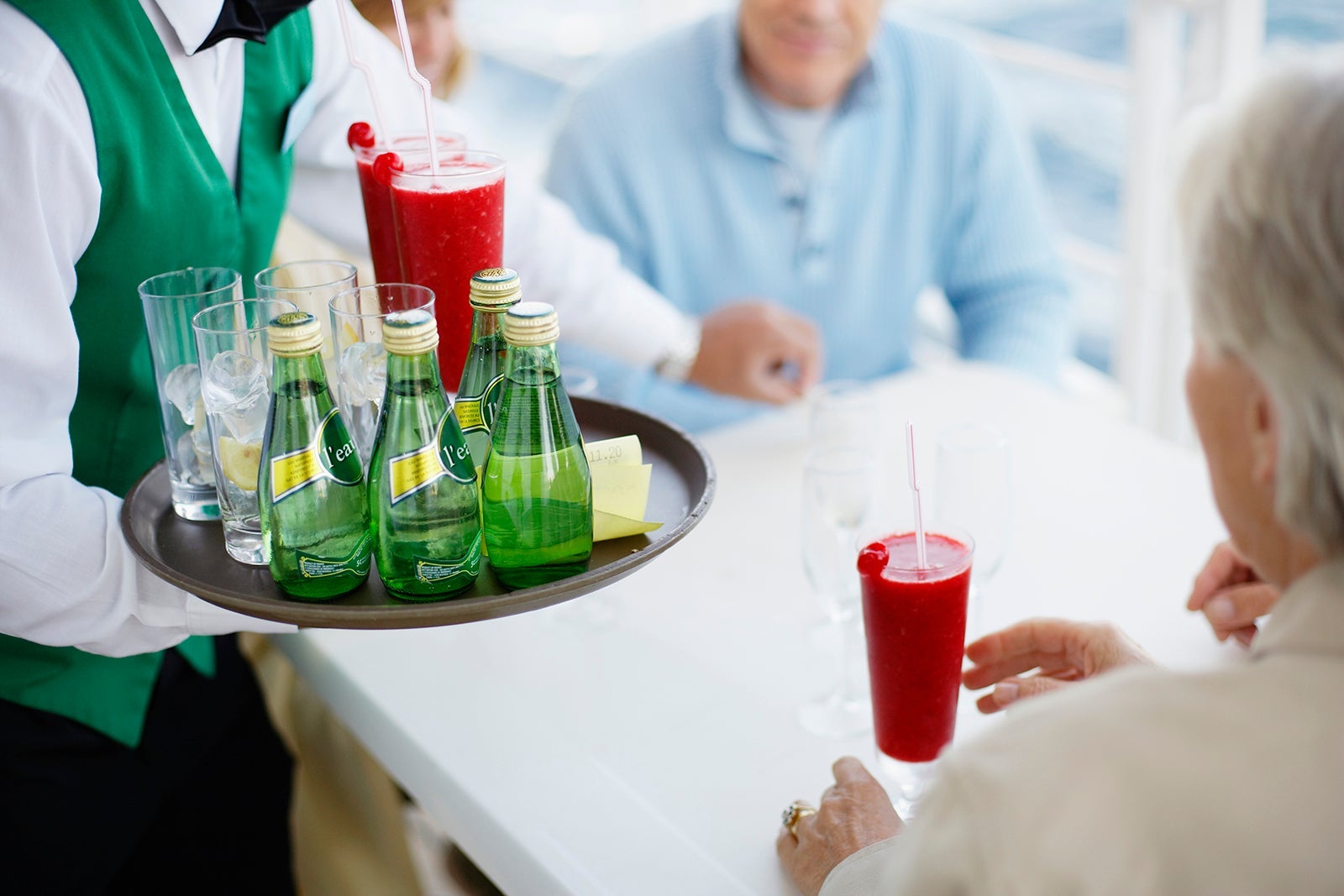 Waiter Serving Cocktails and Water on Cruise Ship