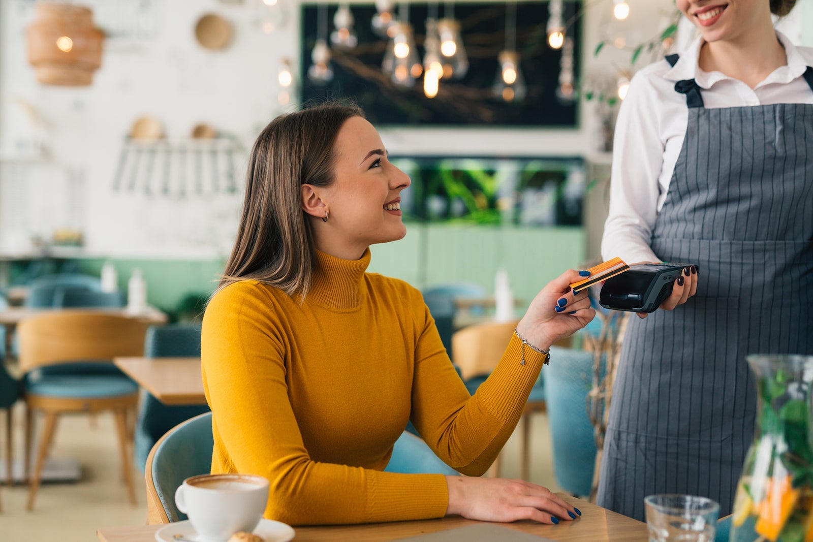 Woman paying for coffee