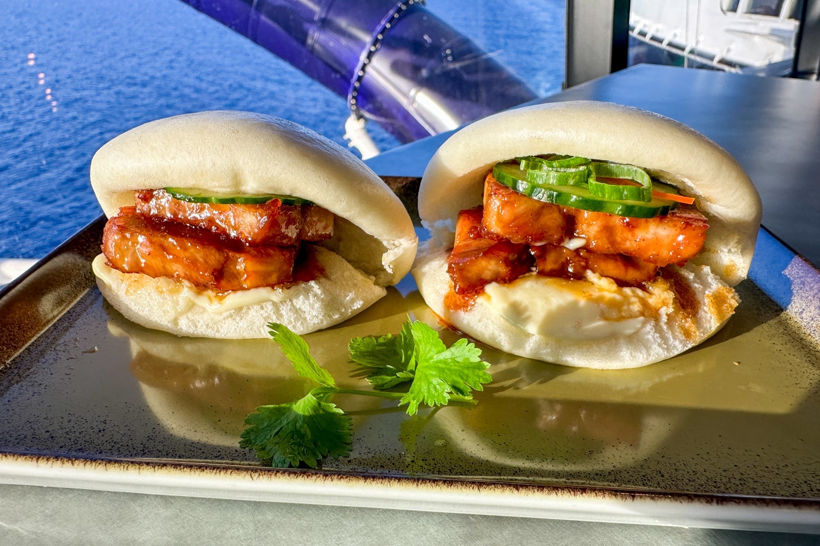 A pair of pork belly bao buns on a plate