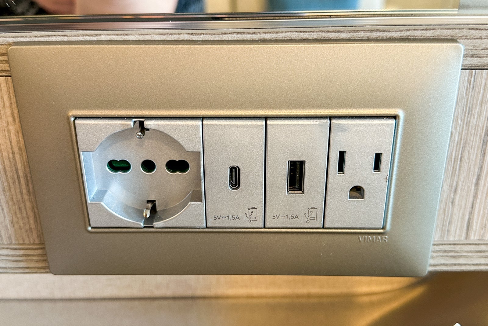 A variety of electrical outlets and USB ports in a cruise ship cabin