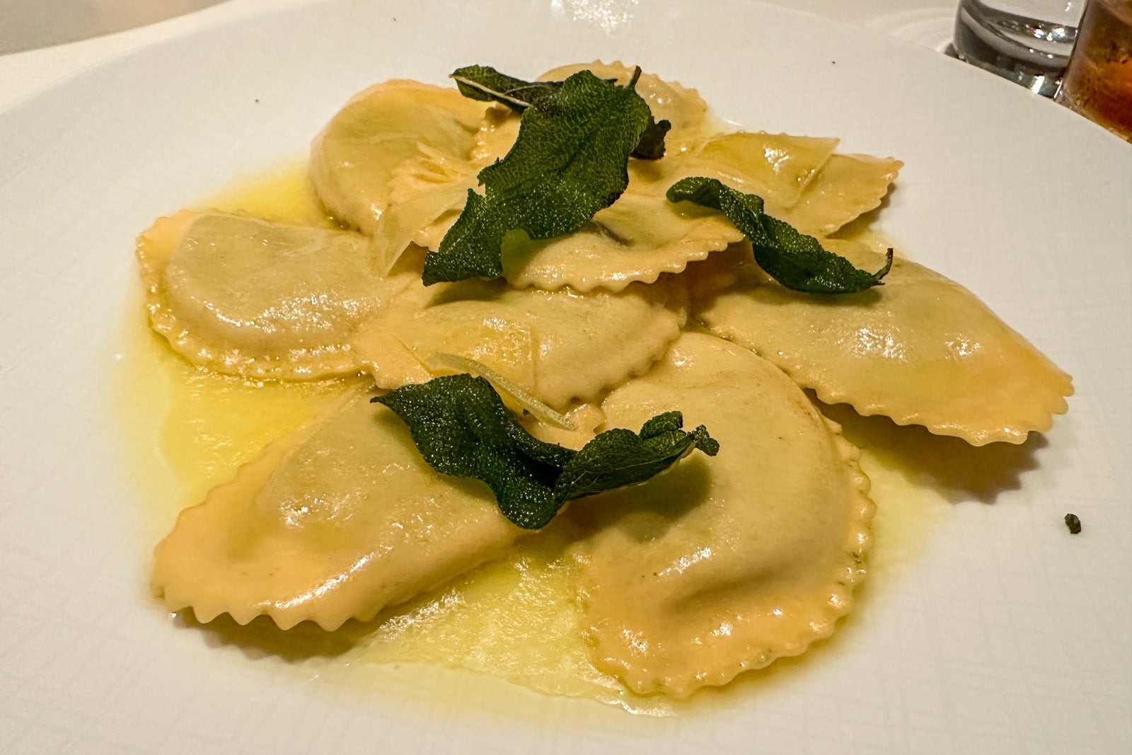 Ricotta and spinach mezzelune on a white plate