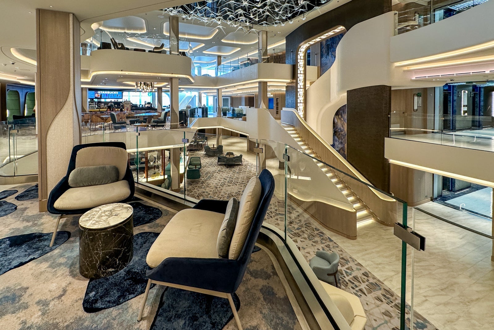 A cruise ship atrium with several decks that look like a maze