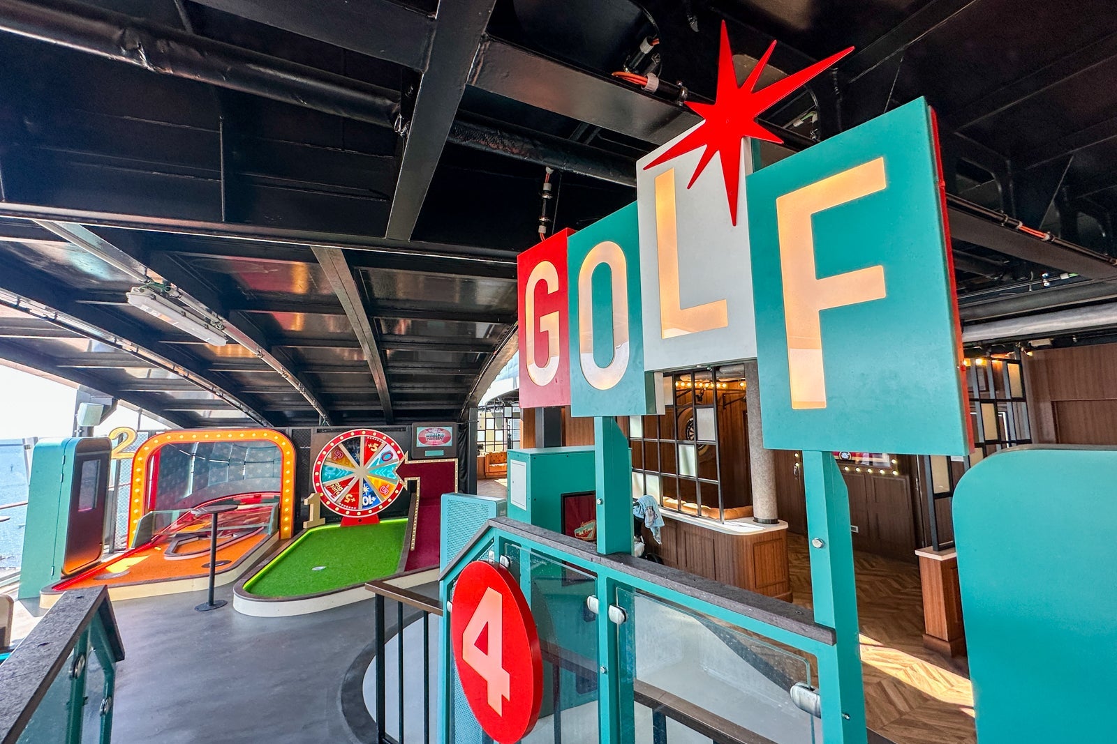 A cruise ship miniature golf course with a 50s retro sign that says "Golf"