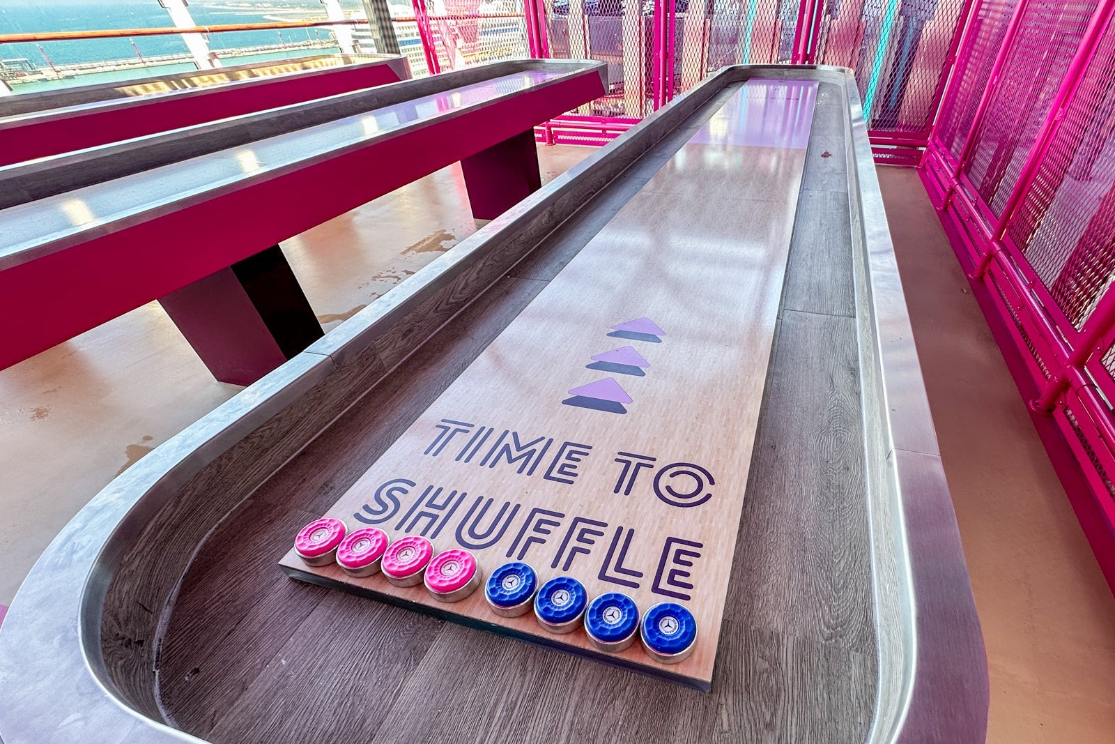 A tabletop shuffleboard game on a cruise ship