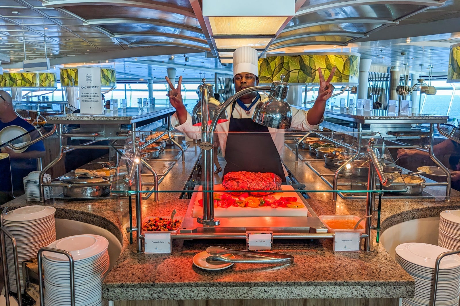 Friendly chef by carving station at cruise ship buffet
