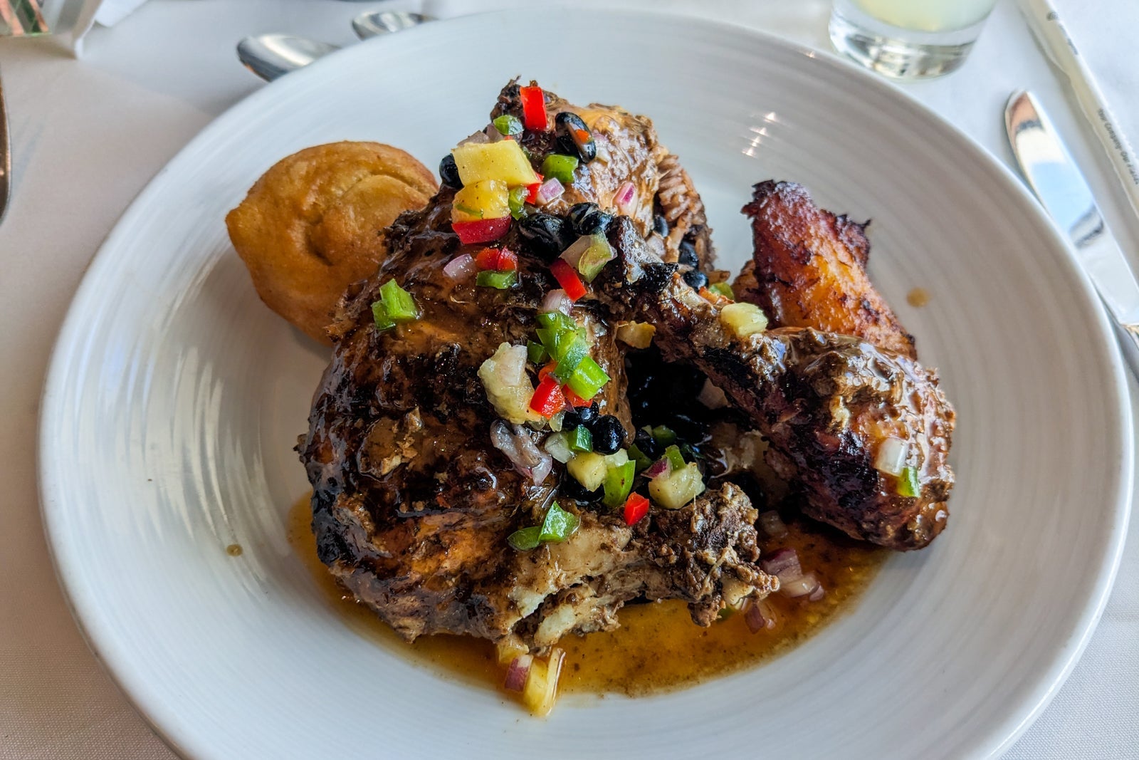 Jamaican dinner on cruise ship with chicken, black beans and diced bell pepper