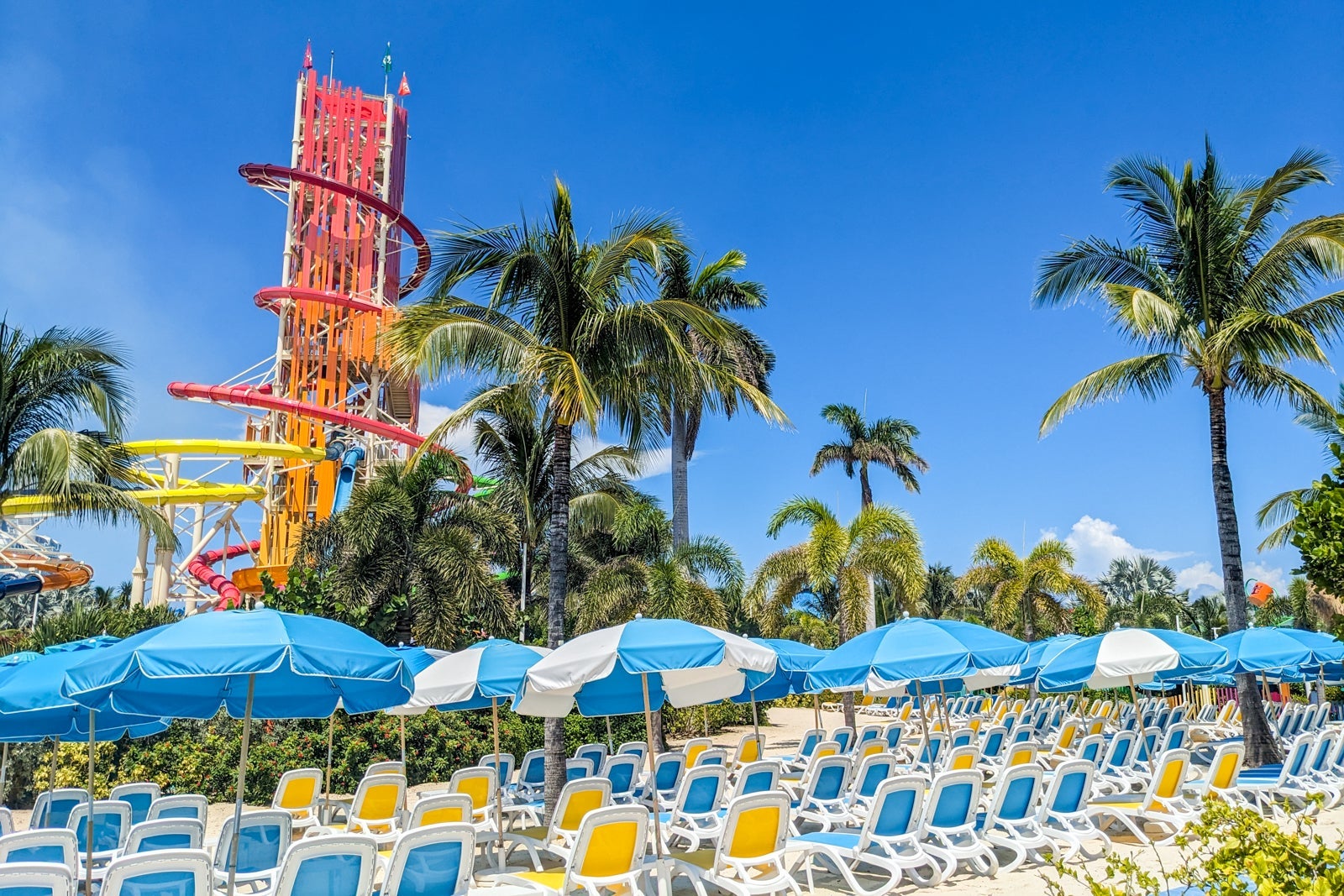 Waterslide tower above several rows of beach chairs at Perfect Day at CocoCay. 