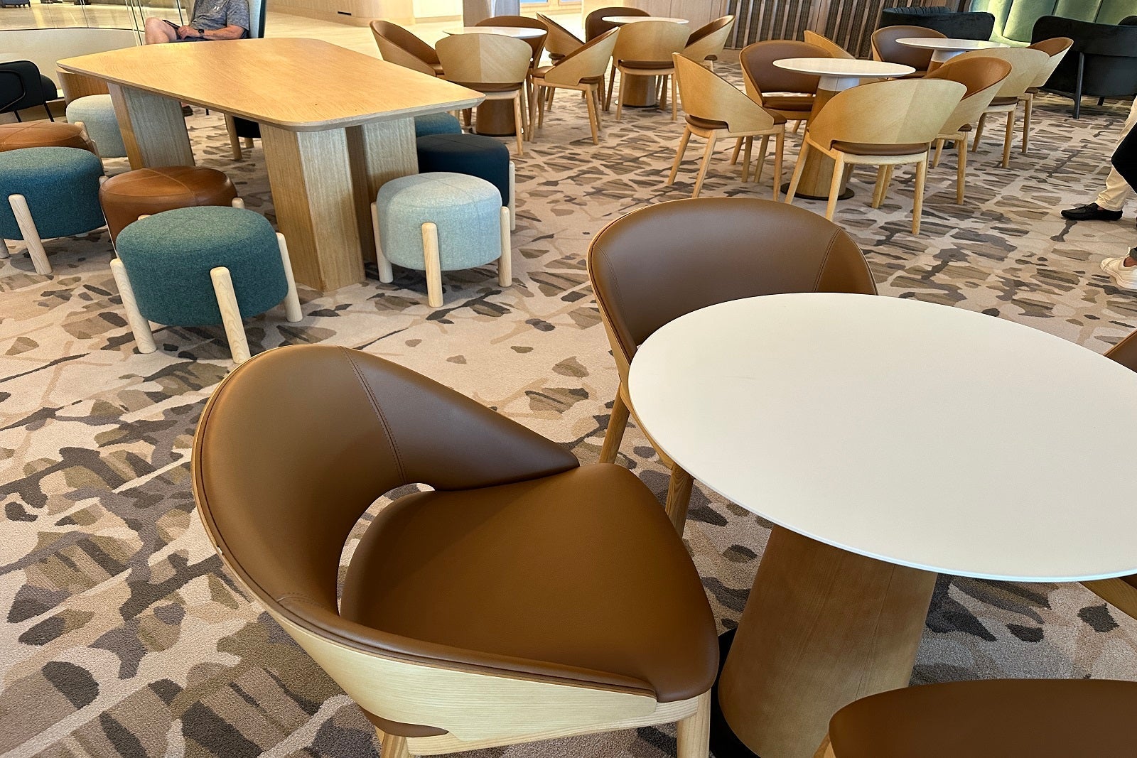 Clusters of tables and chairs in a public area on a cruise ship