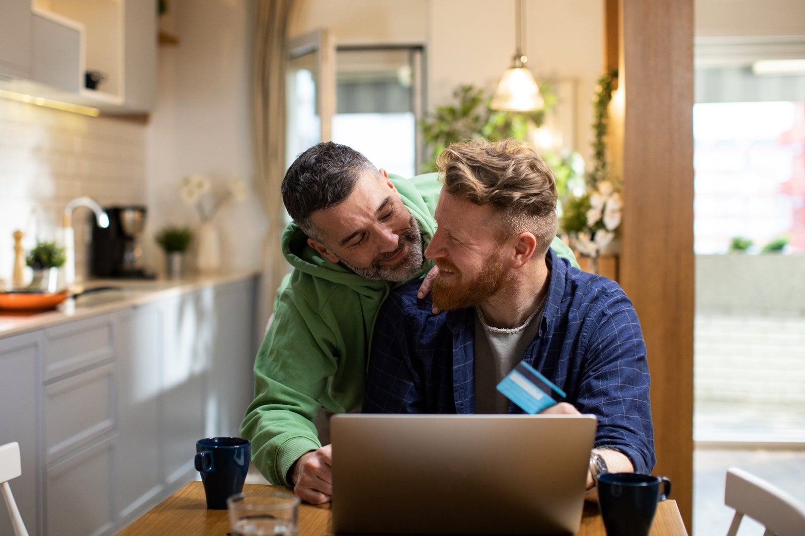 Young male couple online shopping from home