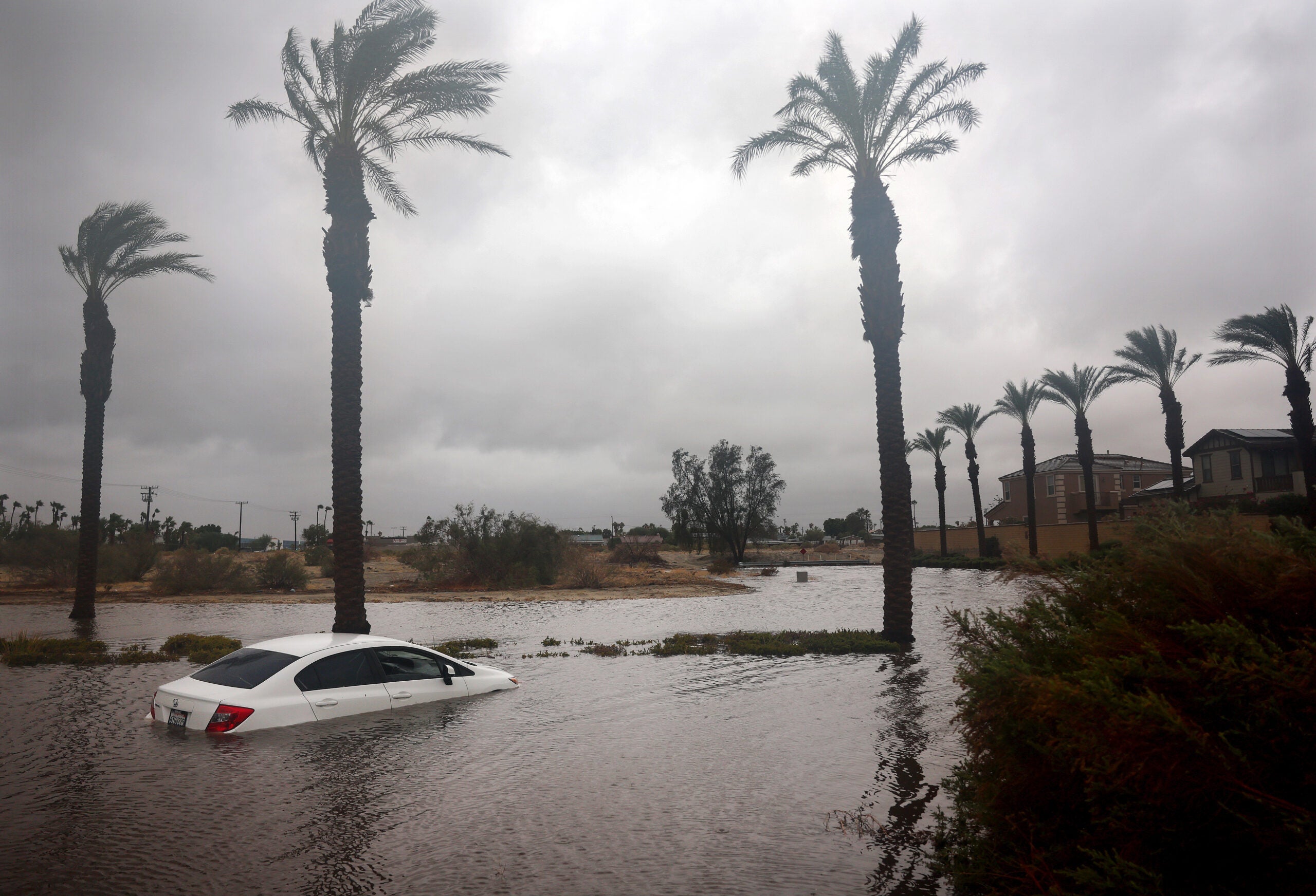 A car is partially submerged in floodwaters as Tropical Storm Hilary moves through the area on August 20, 2023 in Cathedral City, California. Southern California is under a first-ever tropical storm warning as Hilary impacts parts of California, Arizona and Nevada. All California state beaches have been closed in San Diego and Orange counties in preparation for the impacts from the storm which was downgraded from hurricane status. (Photo by Mario Tama/Getty Images)