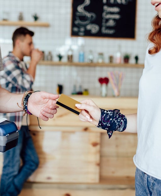 Person handing credit card to make payment